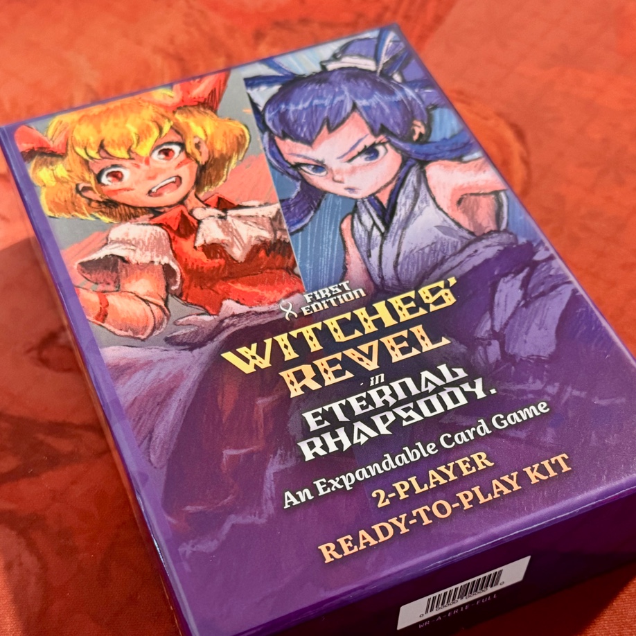 A photo of the same box on a red playmat.