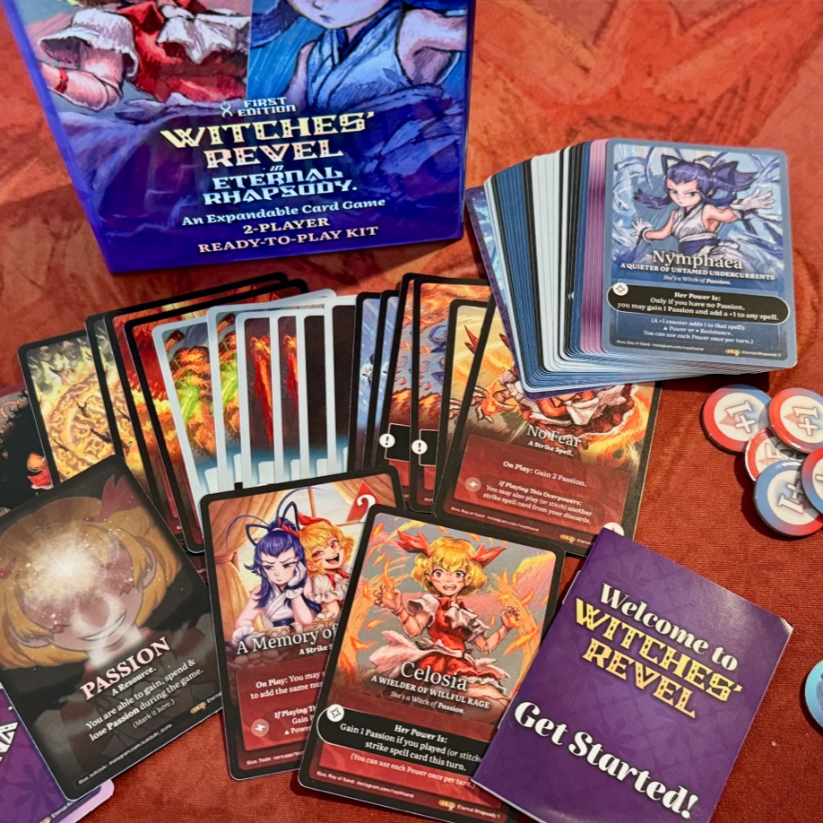 A photo of the contents of the box arrayed on a table: cards, punch-out tokens, and a 'Get Started' manual.